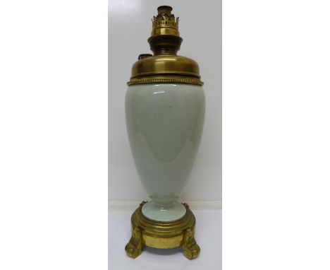 An oil lamp base with gilt ormolu mounts