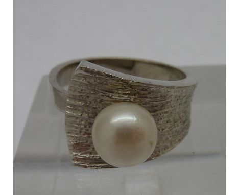 An 18ct white gold and pearl ring, weight 5.8g, size L