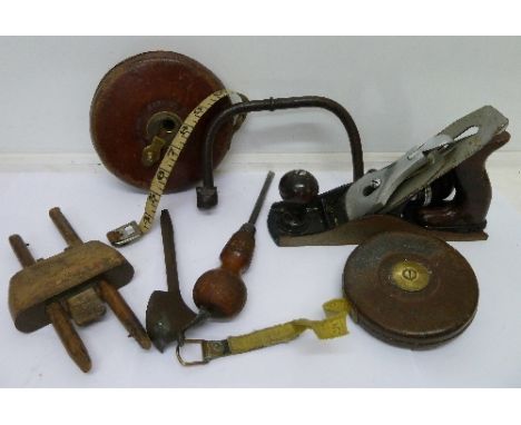 Two leather covered tape measures, a Record No. 4 plane and other tools