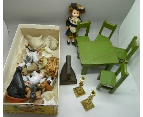 A collection of ceramic farmyard animals, a costume doll, a dolls house table and chairs circa World War II, etc.