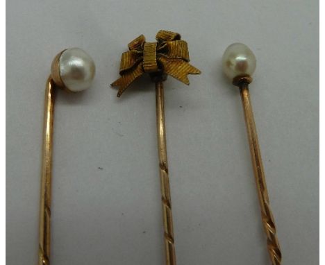 A 15ct gold stick pin and two yellow metal and pearl stick pins, weight 3.1g