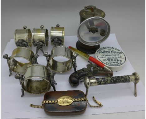 A set of six plated figural napkin rings, a lamp, etc.