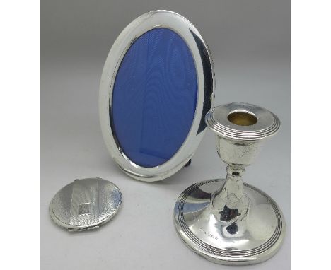 A silver candlestick, a silver powder compact and a silver photograph frame, height of frame 16.5cm