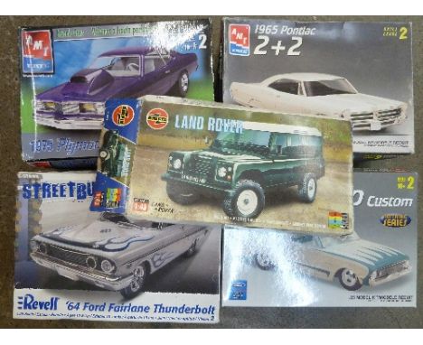 Five plastic model kits of American cars, including Airfix and Ertl, some partly built