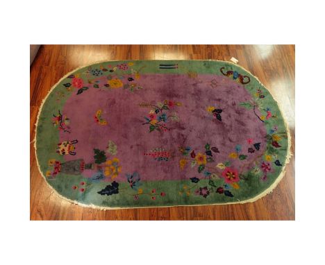 Chinese Art Deco Oval Rug. Butterflies and flowers motif. Measures 6' x 9'. Condition: Some discoloration, wear and loss to f