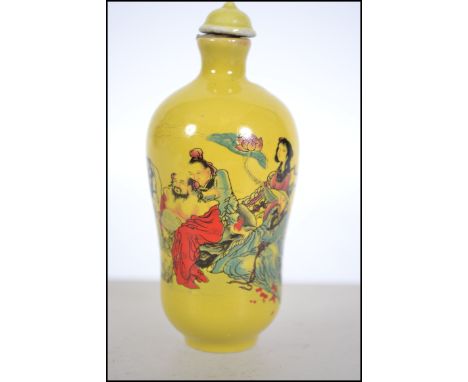 A Chinese Famille Juane ceramic snuff perfume bottle with scenes of merchantmen and Geisha. Complete with stopper having char