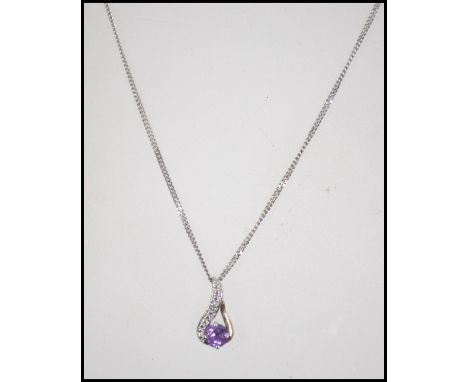 A 9ct white gold diamond and amethyst necklace and pendant. Total weight 3.9g /Chain 44cms			