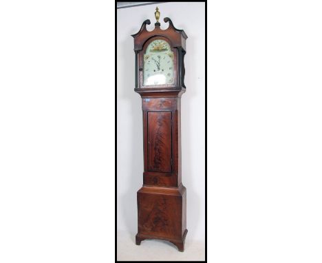 A Late 18th early 19th Century oak and mahogany longcase clock. The case with a twin swan neck pediment above two tapering re