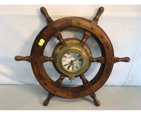 Nautical ships wheel done in solid wood and brass, with centre clock piece (Battery). Measures 46cm in diameter 