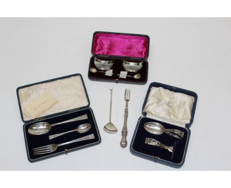 A cased pair of silver navette shape salts with scallop bowl spoons, a cased spoon and pusher, a three piece Christening set,