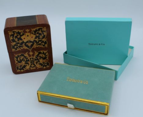 A boxed set of two decks of Tiffany and Co playing cards, together with two 2002 Commonwealth Games decks in a wood card case