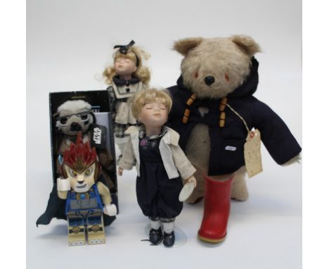 A Gabrielle teddy bear with Paddington ticket and with Paddington/ Duffle coat etc, together with 4 x figures one of which is