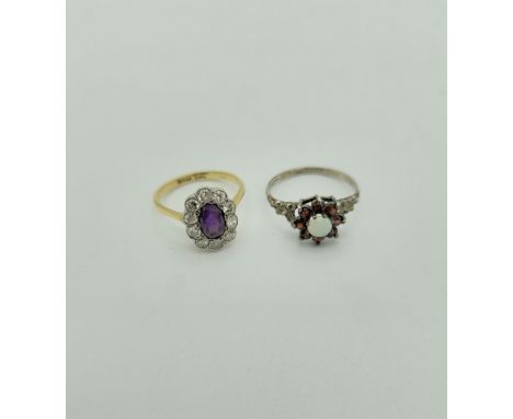 An amethyst and diamond cluster ring, stamped 18ct and plat, size O1/2. Gross weight 3.4gm featuring ten round brilliant cut 