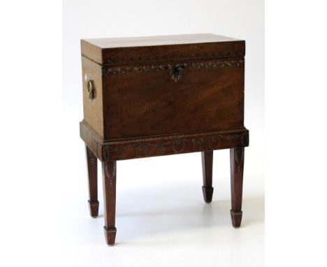 An early 19th century mahogany cellarette with twin brass ring handles and painted decoration, on square supports and spade f