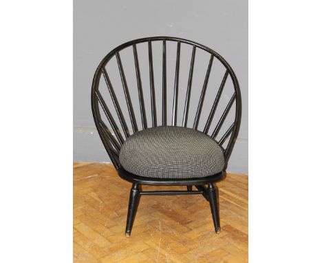 A late 20th century ebonised wide stick back lounge chair of earlier design. Height of back 93cm