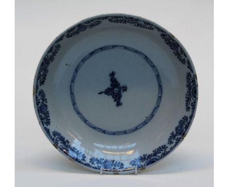 A Dutch Delftware dish of good size, early 19th century, simply decorated underglaze with florets and scaled band. 34.5 cm&nb