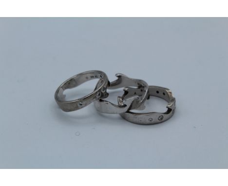 A three piece Georg Jensen ' fusion' jigsaw ring set with round brilliant cut diamonds stamped&nbsp; ''750 Denmark''. Size S.