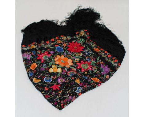 An early 20th century Spanish shawl, brightly woven with bold flowers and trailing foliage, 142 x 132 excluding fringe