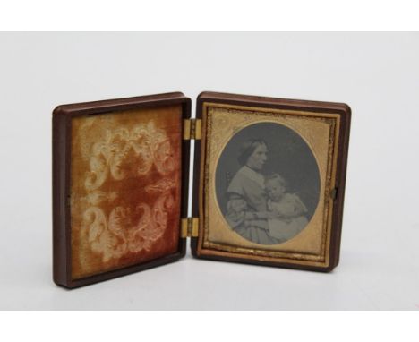 A mid 19th century Bois Durci double cased Ambrotype portrait of a mother and child, height of case 9.5cm