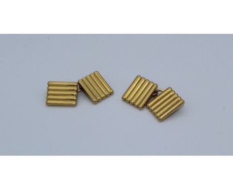 Cartier, a pair of early 20th century 18 carat gold cufflinks, each face of rectangular reeded form. Each signed Cartier, Lon