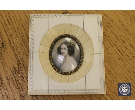 A portrait miniature depicting a lady with flowers in her hair, 10.5 cm x 9.5 cm.