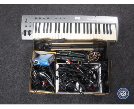 An M-Audio Key Studio 491I keyboard together with a box containing two Sennheiser free ports, camera tripod, guitar leads, Fe