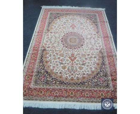 A Keshan carpet on beige ground, 230 cm x 160 cm 