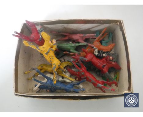 A box containing hand-painted metal Chad Valley figures of horses and jockeys