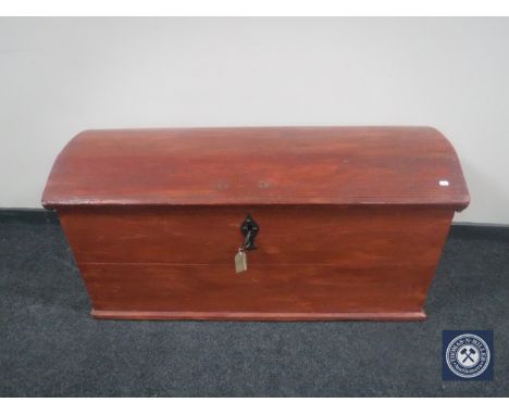 An antique painted oak dome top trunk