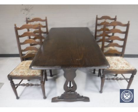 An oak refectory dining table together with a set of four ladder back chairs