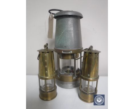 A chrome and brass Wolfe Type E miner's lamp by Morris Limited of Sheffield and two further miniature brass oil lamps 