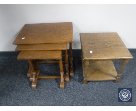 A nest of three oak tables together with an oak lamp table