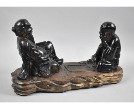 An Oriental Carved Wooden Study of Two Seated Gents Playing Checkers , 43cm wide, One Finger AF but Present 