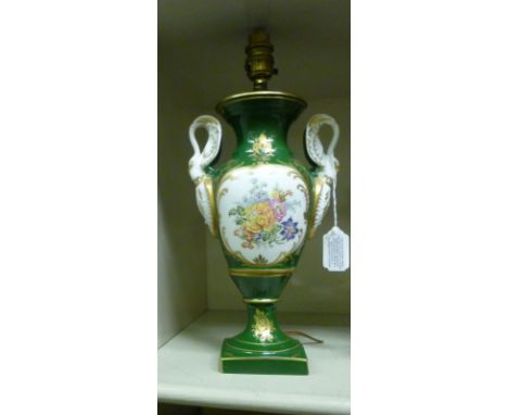 An early 20thC Limoges porcelain pedestal vase design table lamp, having moulded swan neck handles, decorated with a floral v