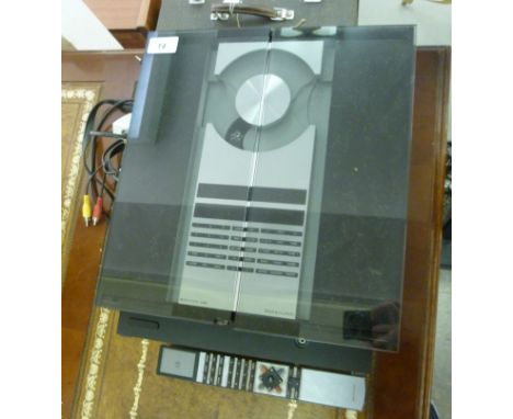 A Bang & Olufsen Beosystem 2300 compact disc player with a pair of chromium plated steel cased tower speakers  52''h with rem
