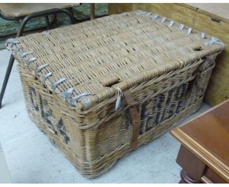 A woven cane and lashed hide laundry hamper  16''h  30''w       BSR