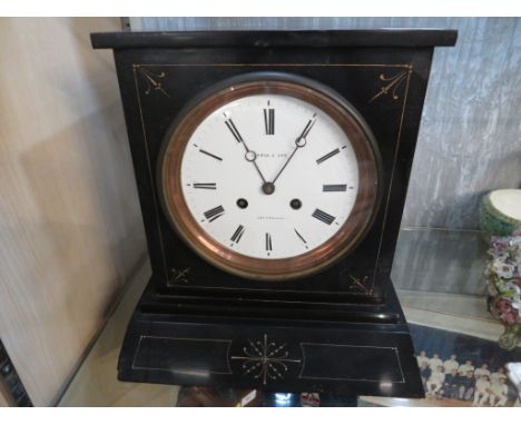 FURBER AND SON CHELTENHAM BLACK STONE MANTEL CLOCK WITH ENAMEL DIALS.