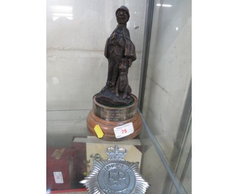 A DORSET POLICE HELMET BADGE, TOGETHER WITH A COMPOSITE FIGURE OF A POLICEMEN ON A PRESENTATION STAND