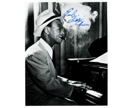 HINES EARL 'FATHA': (1903-1983) American jazz pianist. Signed 8 x 10 photograph, an atmospheric image of Hines seated in a th