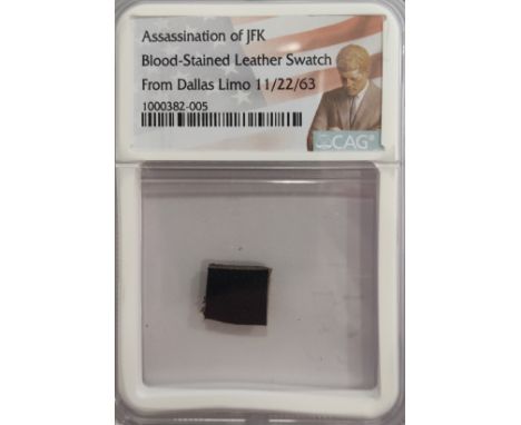 [KENNEDY JOHN F.]: (1917-1963) American President 1961-63. A very small 0.5 x 0.5" swatch of blood-stained blue leather uphol