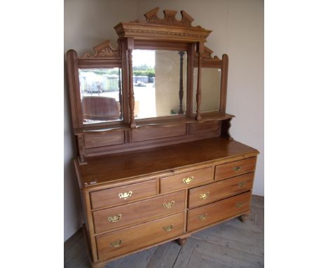 Large Victorian beech style dresser with raised triple bevel edged mirror back with central shelf above three short and four 