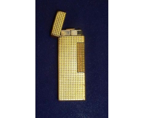 Narrow gold plated Dunhill pocket lighter with engine turned square block detail, the base stamped Dunhill Made in Switzerlan