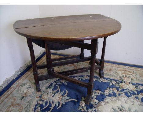 19th C oak drop leaf gate leg table on turned cannon barrel supports (104cm x 109cm x 72cm) 