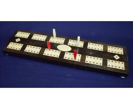 Edwardian mahogany and ivory inset cribbage board on four raised ivory bun feet with slide open compartment to the underneath