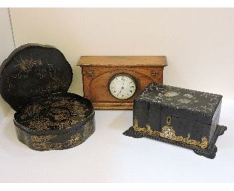 A Japanese lacquer box, with fitted interior, a Victorian papier mâché tea caddy, and an oak mantel clock