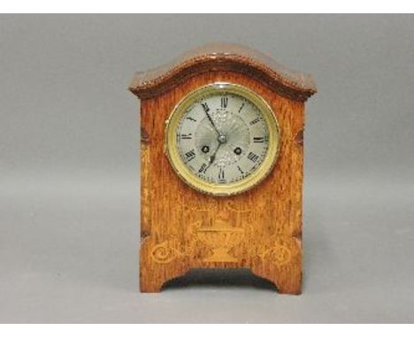 An Edwardian inlaid mantel clock, the silvered dial inscribed 'Terry & Co, Manchester', striking on a gong, 28cm high
