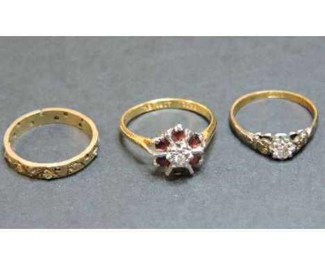 A diamond and ruby cluster ring, marked 18ct, a single stone diamond ring marked 18ct, and a gold synthetic spinel ring marke