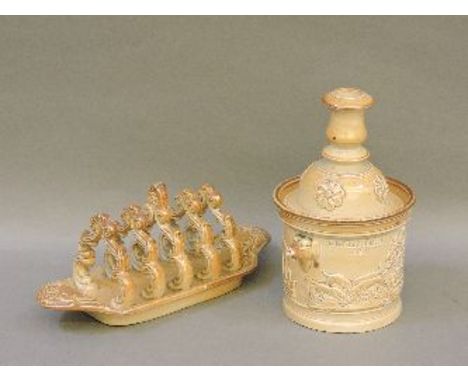 A 19th century Derbyshire brown stoneware toast rack, impressed 'S & H Briddon', and a hunting scene tobacco jar with candles
