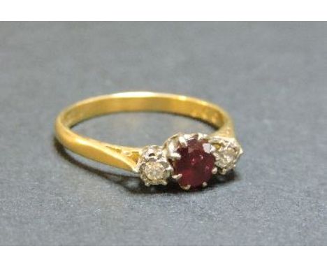 An 18ct gold three stone ruby and diamond ring