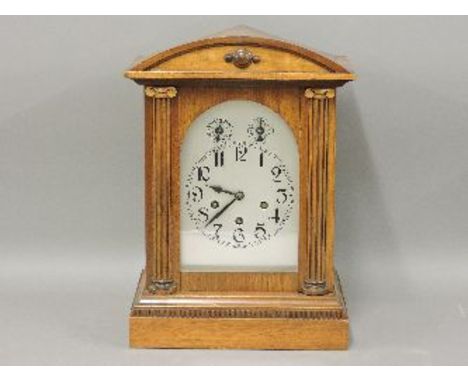 An Edwardian mantel clock, the silvered dial with chime/silent, slow/fast dials, the door with half round ionic pilasters, th